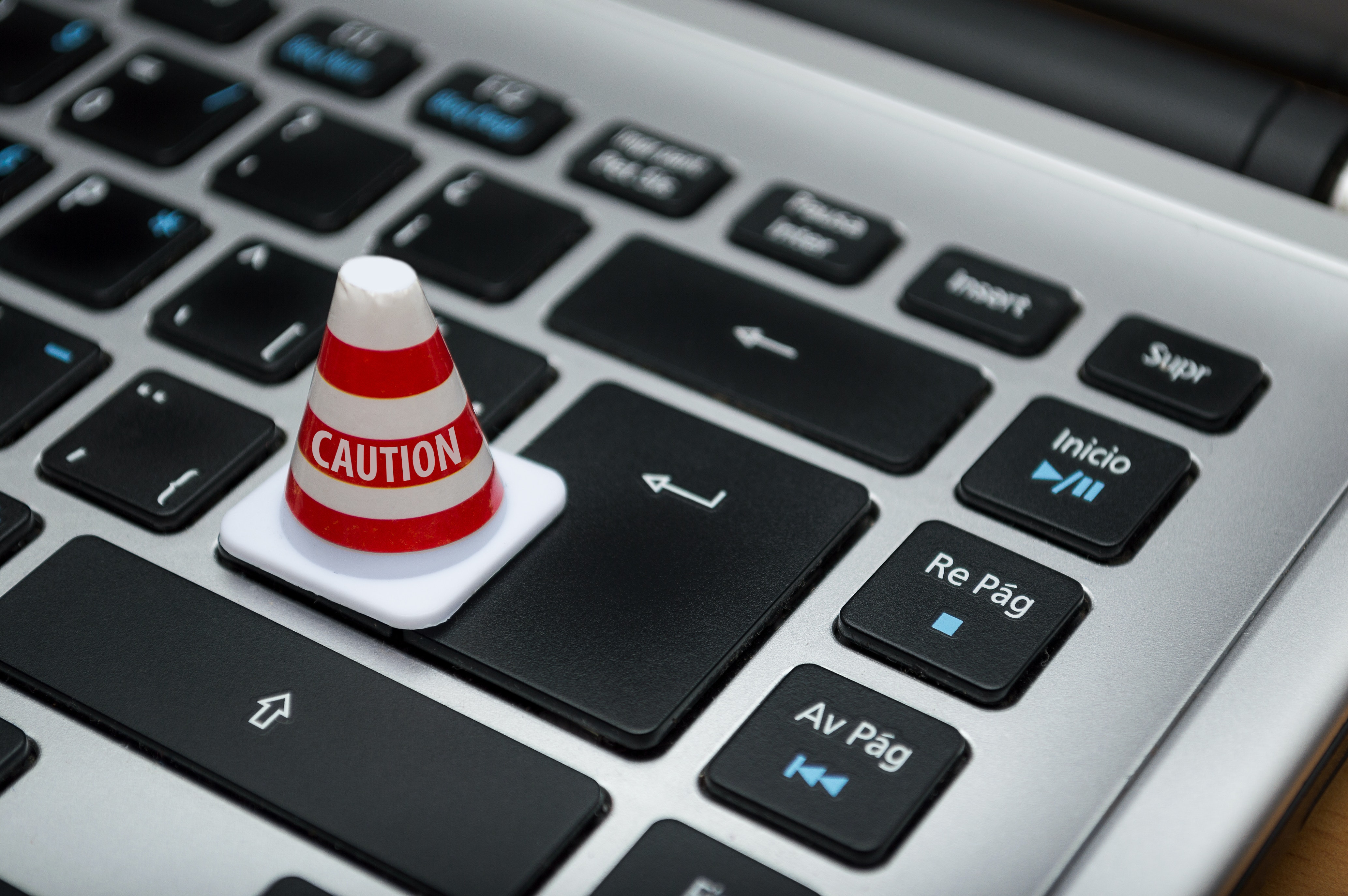 small caution cone on laptop return key