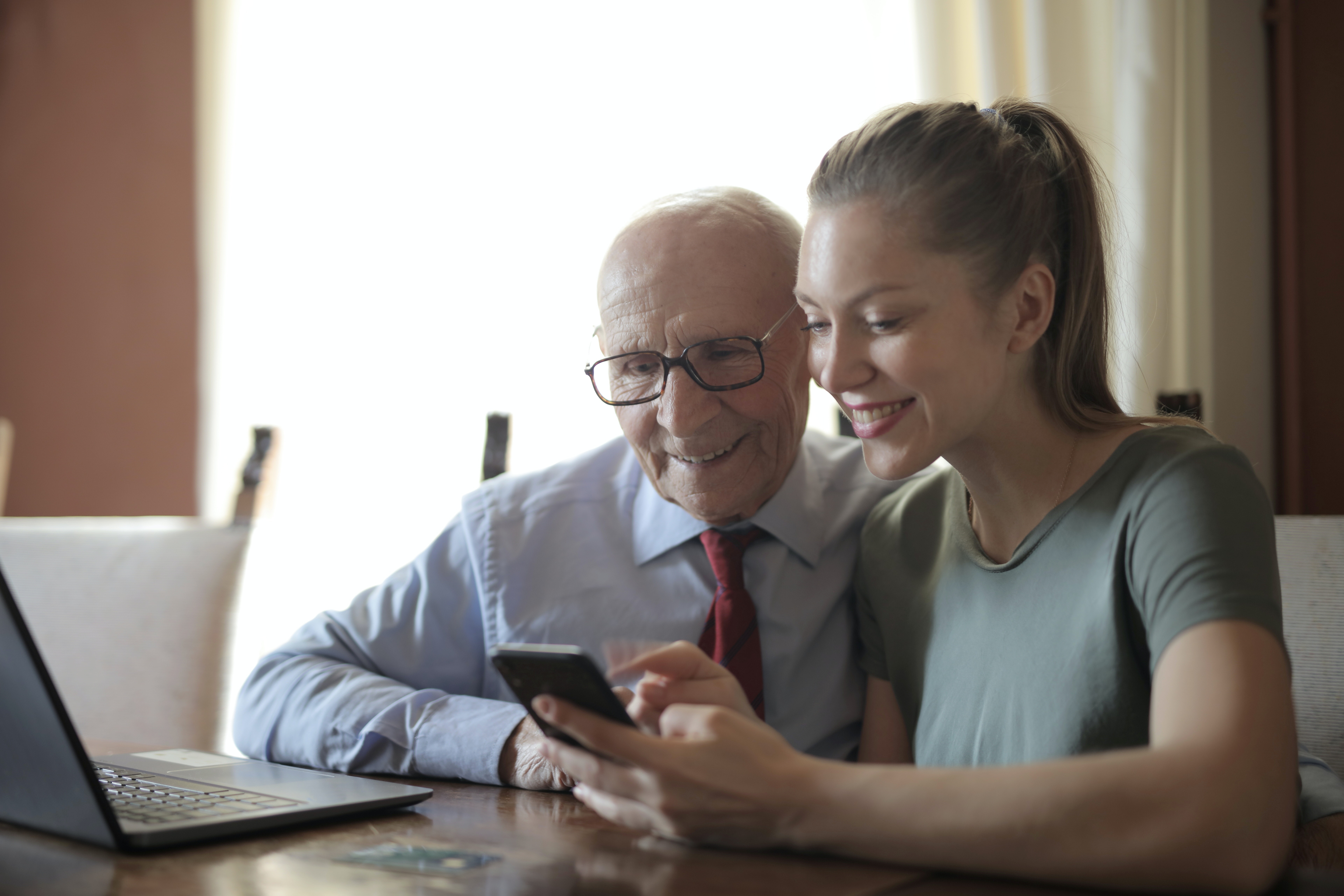 two people interacting with a smart device