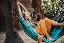 person relaxing and reflecting on nature in a hammock chair