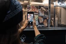 taking a photograph of a restaurant's offerings